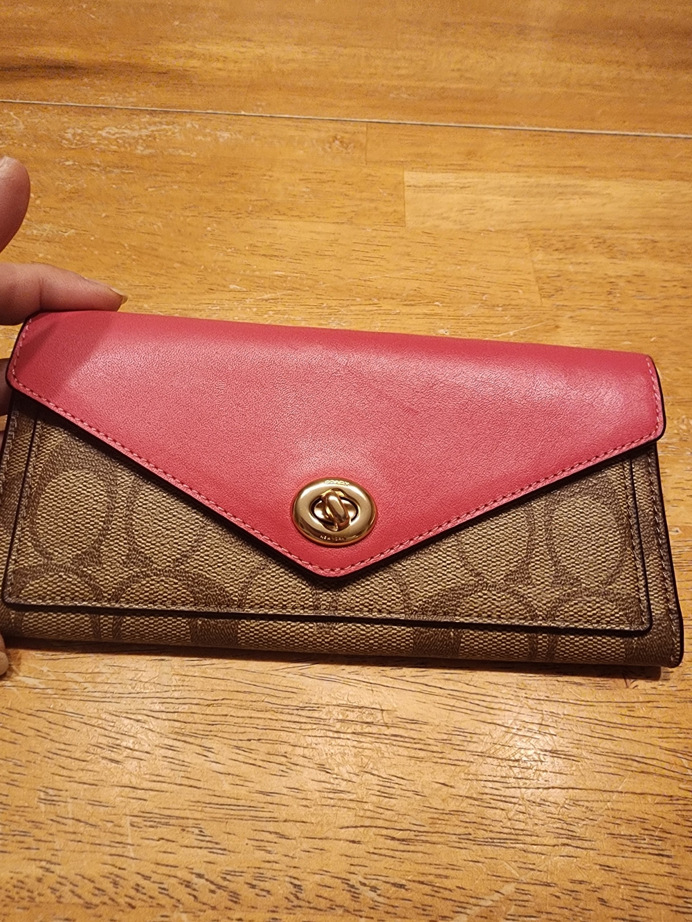 Coach turnlock long wallet featuring the iconic brown signature coated canvas